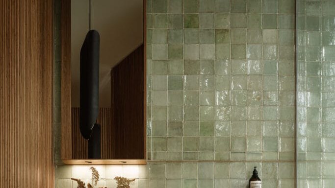 Spa-style bathroom tiles with floating vanity and black fixtures